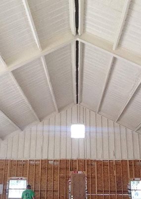 Spray foam insulation covering a gable roofline during a Johnson Mechanical Services insulation job